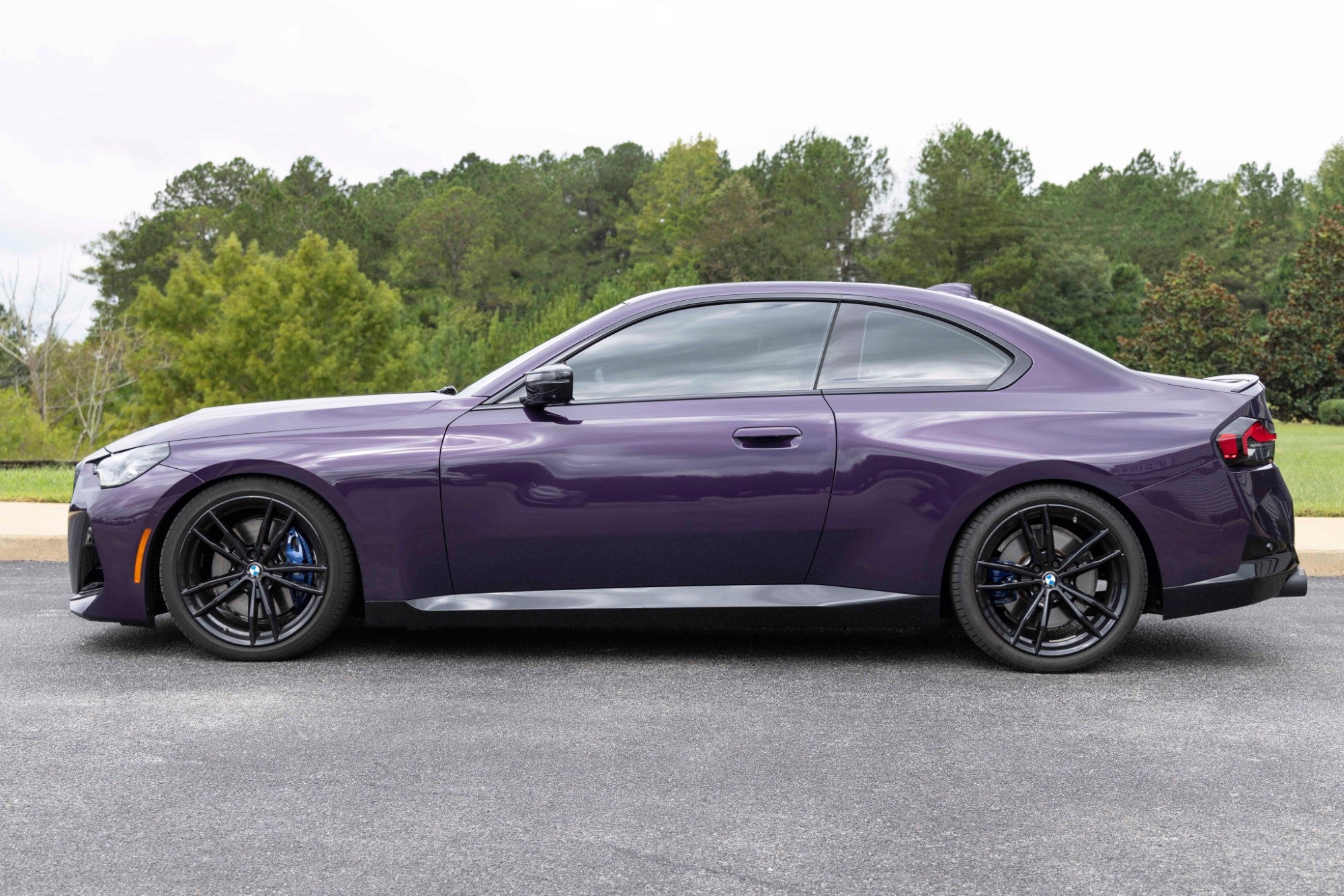 Dinan suspension system for BMW M240i XDrive, featuring performance springs, bump stops, and perches to enhance both stance and handling.